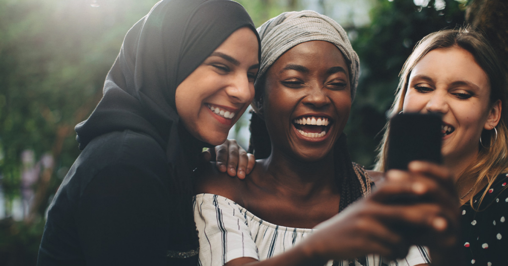 group of women smiling and enjoying spending time with each other