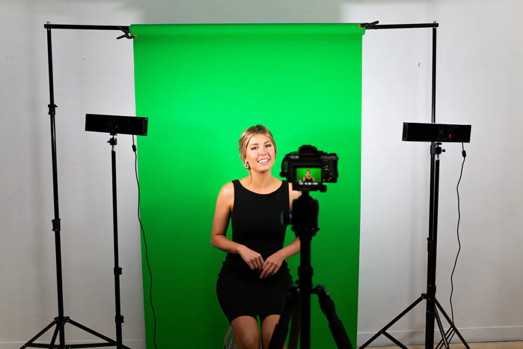 image showing woman in front of green screen backdrop