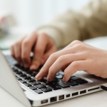 person typing on a laptop