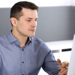 a man looking at a computer