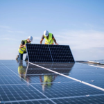 Riax employee installing solar panels in a building