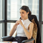 CFO in a office, thinking.