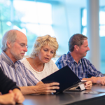 A faculty in a meeting discussing about education lead generation