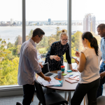 A marketing team discussing about Google Ads vs Microsoft Ad