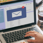A person working on a laptop checking how HubSpot marketing email works