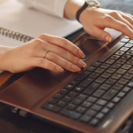 A person searching for Sales tracking software on her laptop